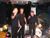 ﻿Von links: Herman Rarebell, Pete York und Chaly Antolini zu Beginn des 'Tag der offenen Tür' am 5.12.2004 auf der Bühne im df-München.